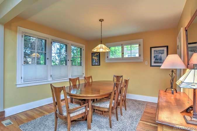 2536 Glencoe Street Denver, CO 80207 - Photo 4 of 26 a dining room with furniture and window