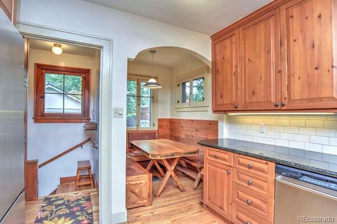 2536 Glencoe Street Denver, CO 80207 - Photo 5 of 26 a kitchen with stainless steel appliances granite countertop a stove a sink and a microwave