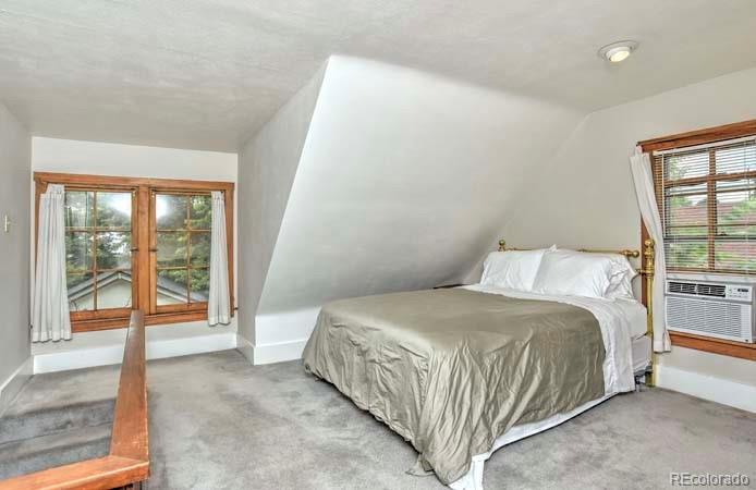 2536 Glencoe Street Denver, CO 80207 - Photo 8 of 26 a bedroom with a bed and a large window
