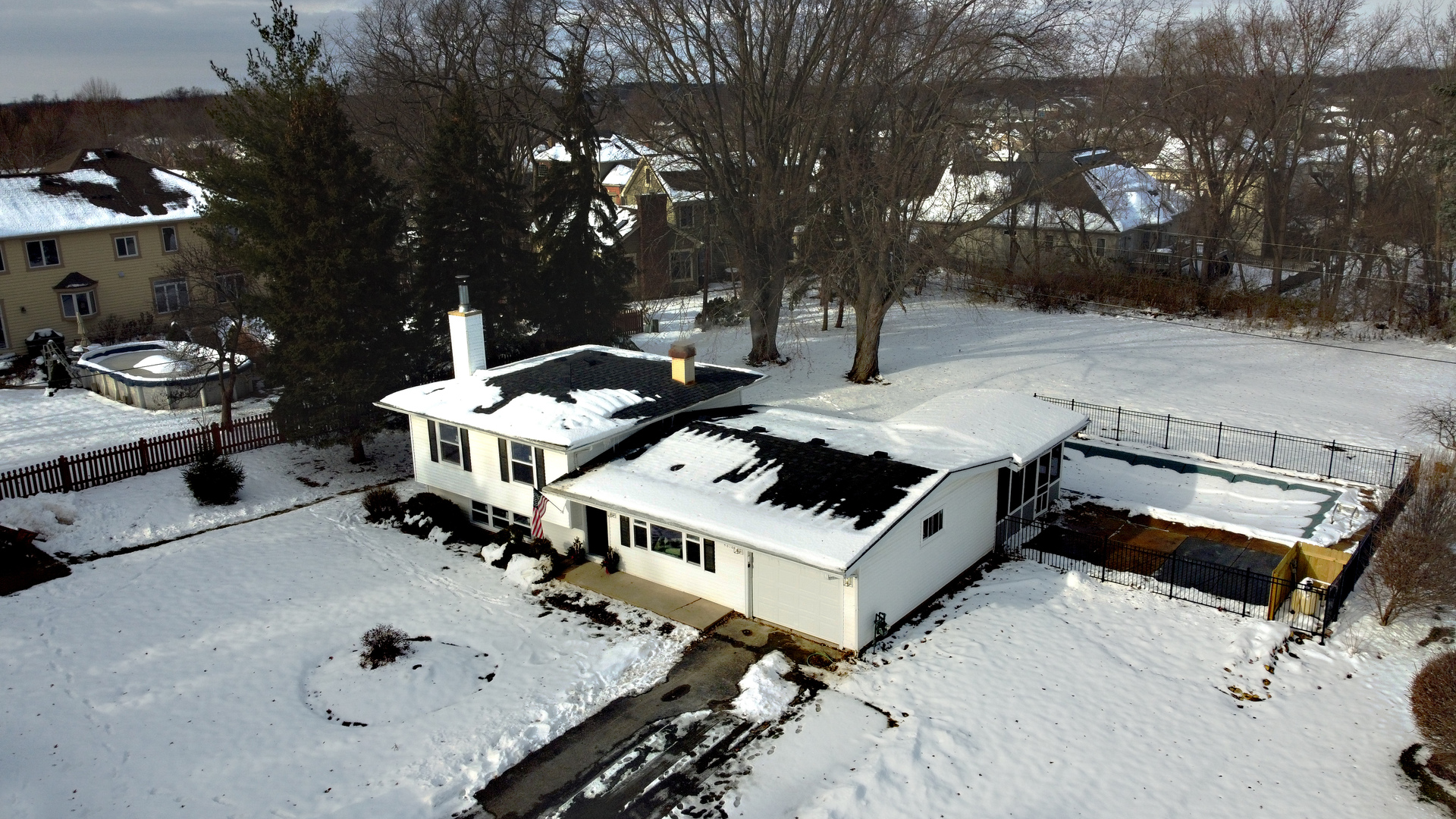 4818 Strong Road Crystal Lake, IL 60014 - Photo 30 of 31 a view of a white house with a yard covered in snow