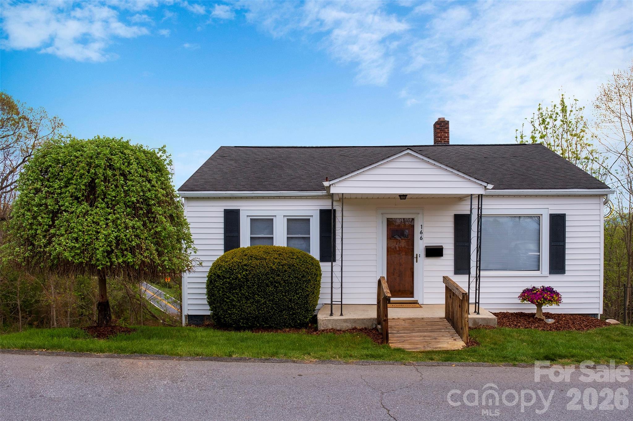166 Spruce Street Canton, NC 28716 - Photo 1 of 23 a front view of a house with a yard and garage