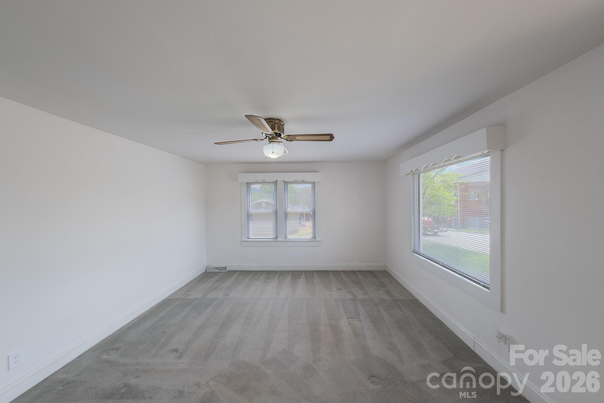 166 Spruce Street Canton, NC 28716 - Photo 7 of 23 wooden floor in an empty room with a window