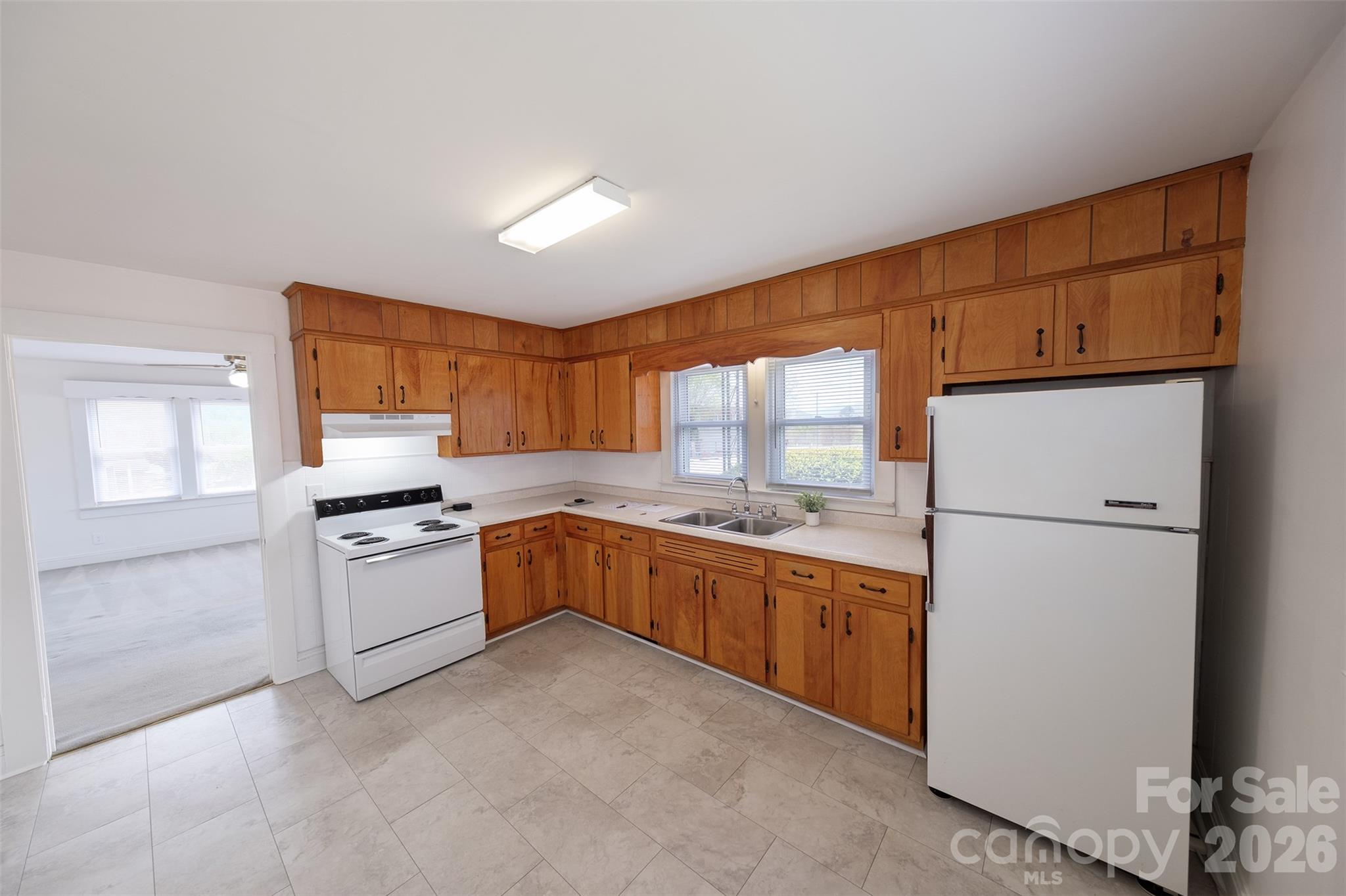 166 Spruce Street Canton, NC 28716 - Photo 9 of 23 a kitchen with a refrigerator stove top oven a sink and dishwasher