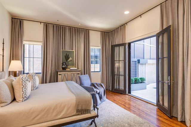 a bedroom with a large bed and a large window