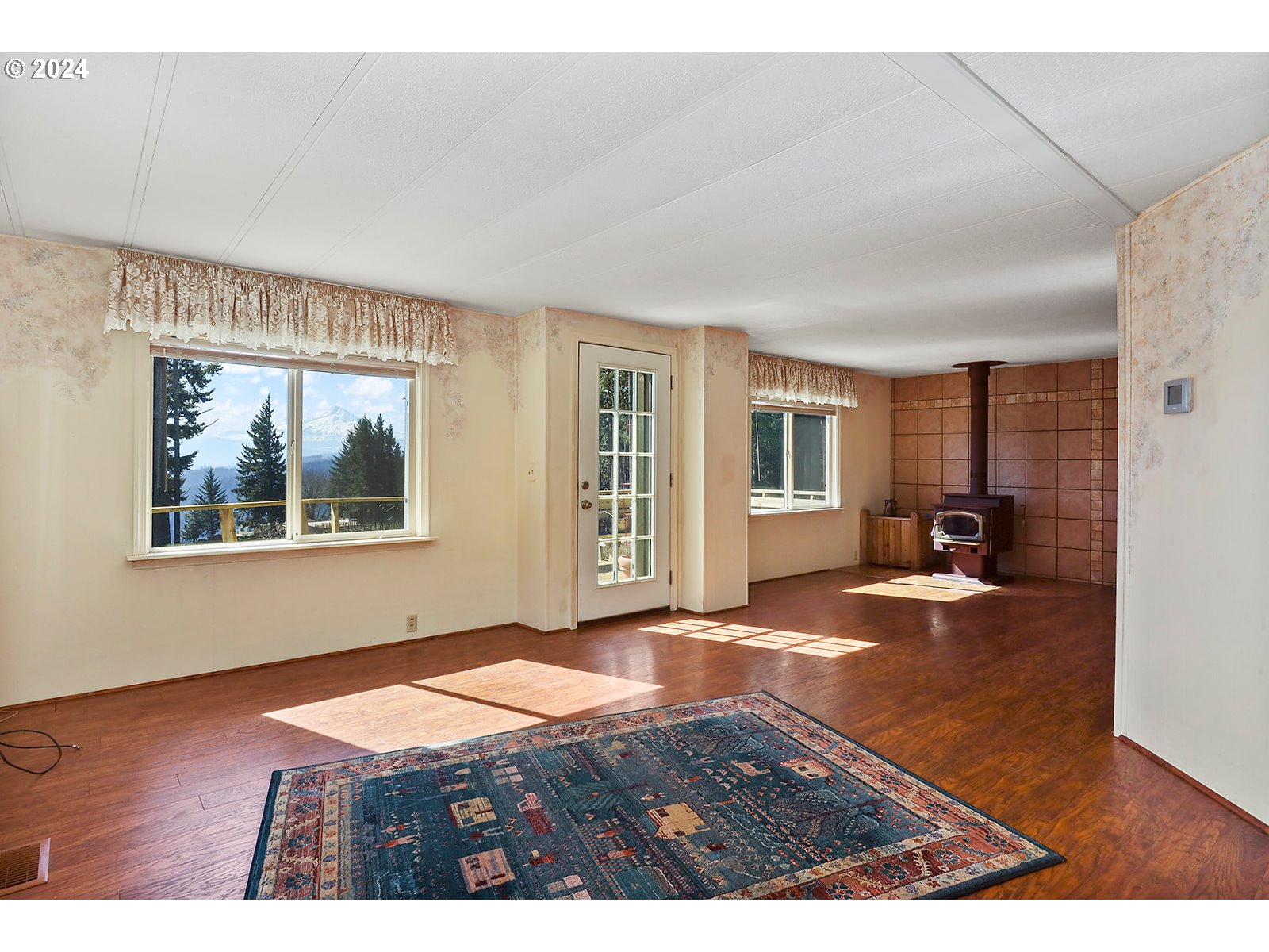 42 George Road Underwood, WA 98651 - Photo 7 of 45 a view of an empty room with wooden floor and a window