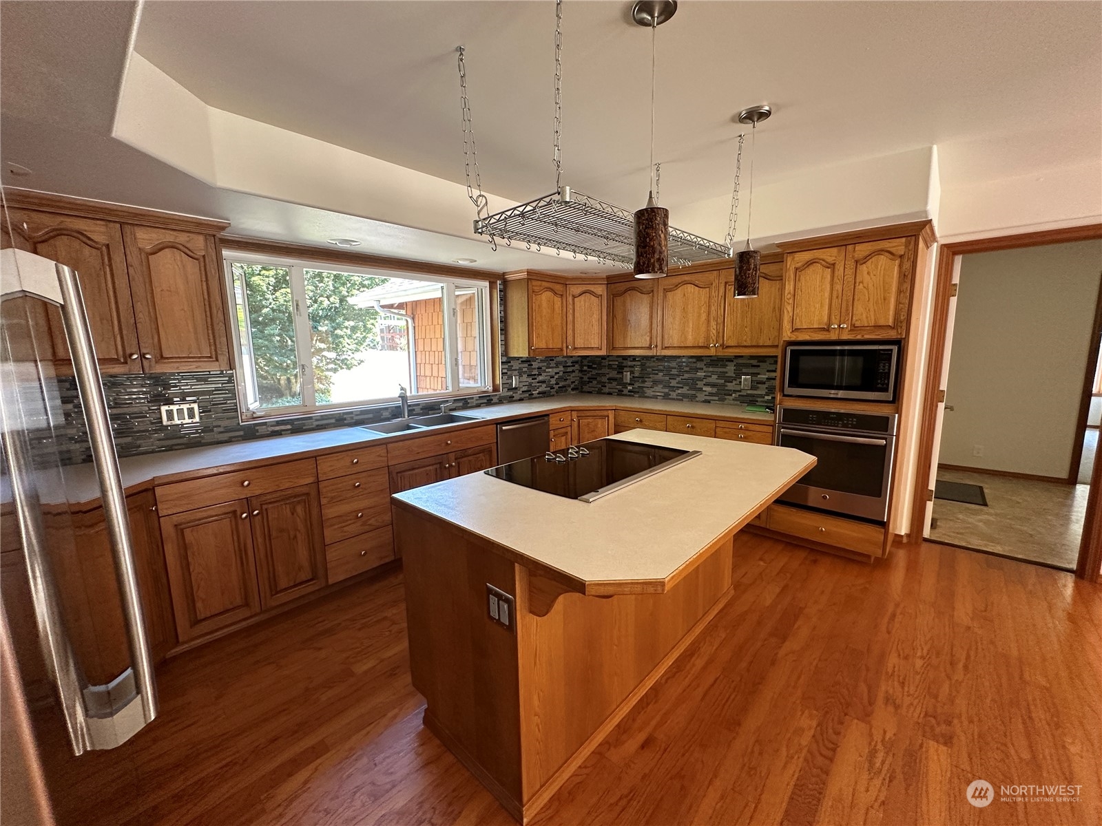 1893 Kelly Road Bellingham, WA 98226 - Photo 10 of 27 a kitchen with a sink a window a wooden floor and stainless steel appliances
