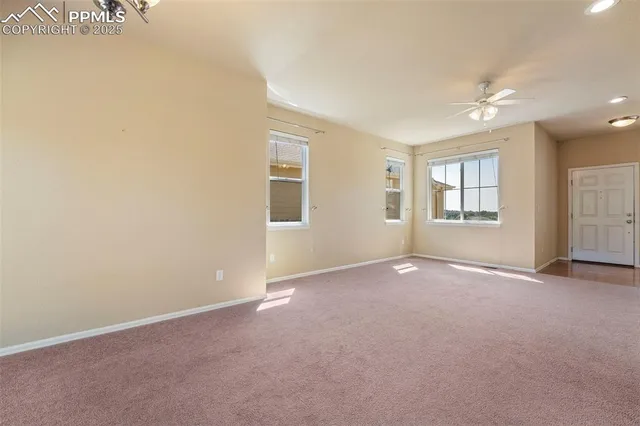 an empty room with windows and closet