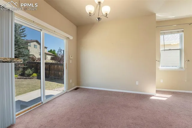 a view of an empty room with glass door