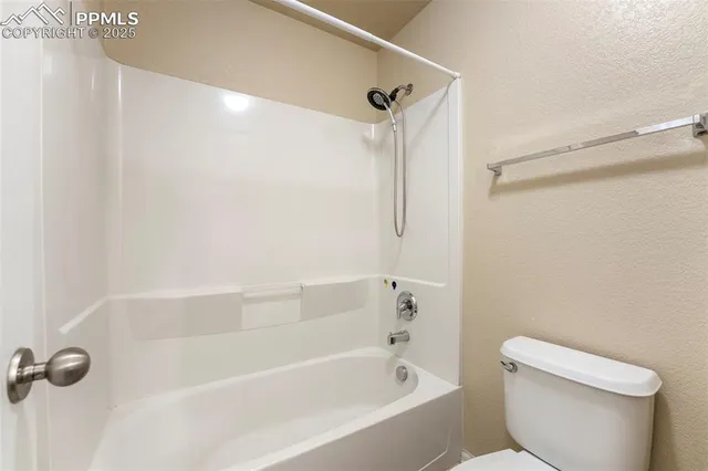 a bathroom with a bathtub and a toilet