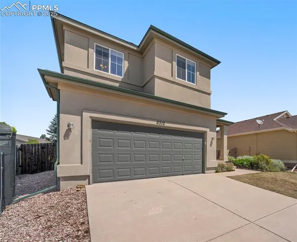 a front view of a house with a garage