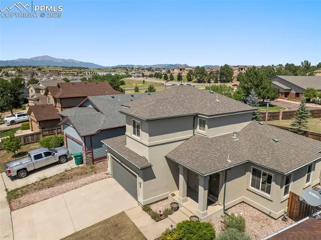 an aerial view of residential houses with outdoor space