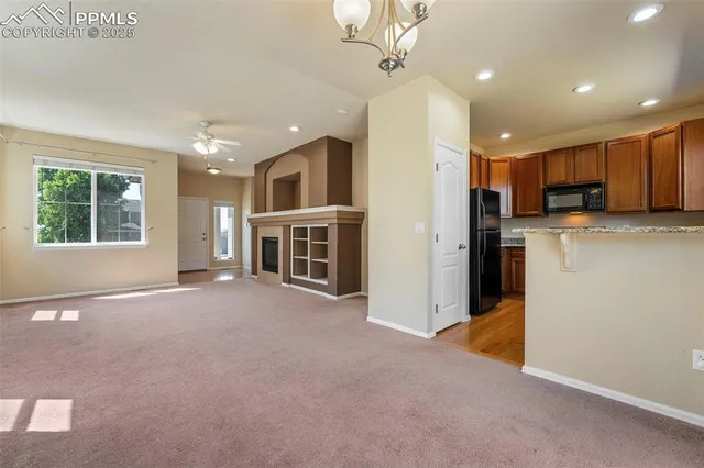 a view of a kitchen with a sink and a refrigerator