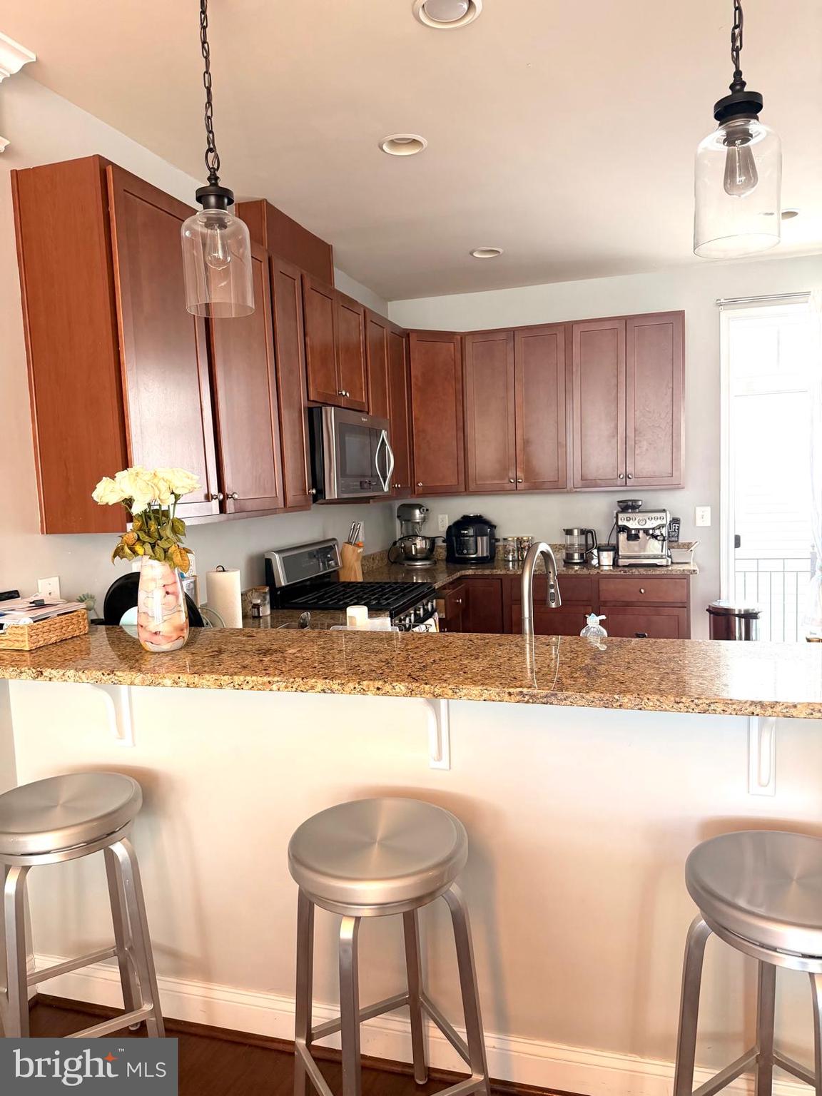 81 Linden Place Baltimore, MD 21286 - Photo 27 of 27 a kitchen with granite countertop a sink stove and refrigerator