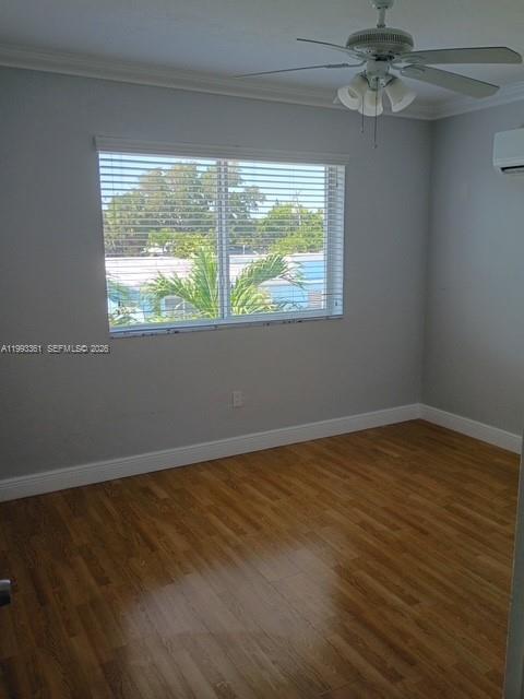 755 83rd Street, Unit 3 Miami Beach, FL 33141 - Photo 11 of 24 a view of an empty room with wooden floor and a window