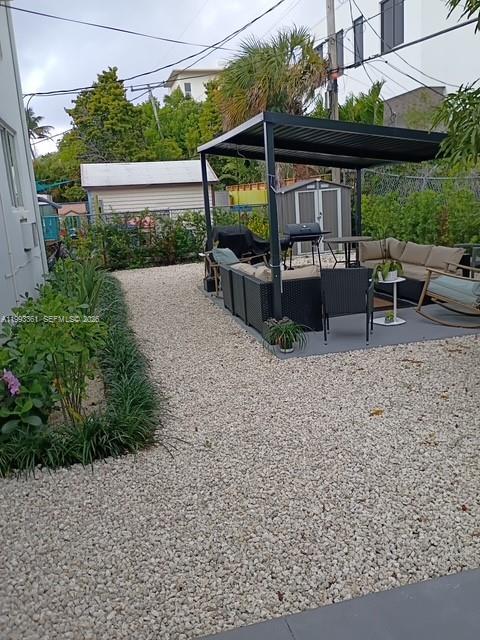 755 83rd Street, Unit 3 Miami Beach, FL 33141 - Photo 12 of 24 a view of a chair and table in backyard