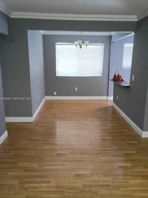 755 83rd Street, Unit 3 Miami Beach, FL 33141 - Photo 14 of 24 a view of a livingroom with wooden floor and a window