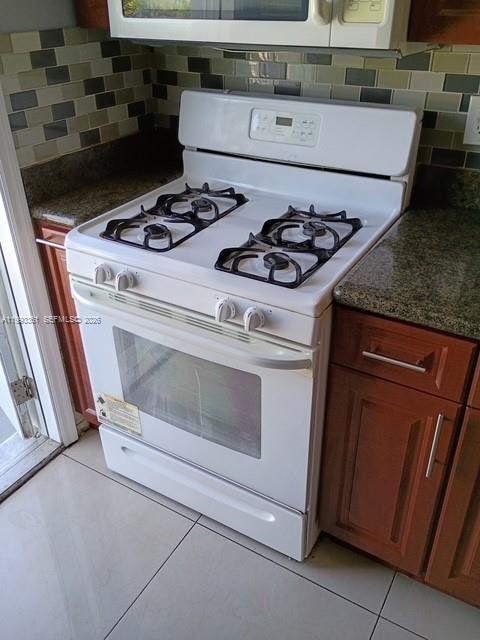 755 83rd Street, Unit 3 Miami Beach, FL 33141 - Photo 16 of 24 a stove top oven sitting inside of a kitchen