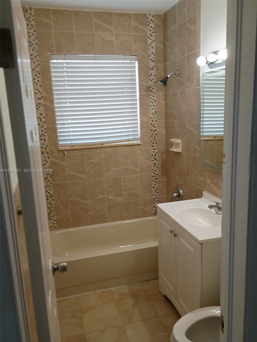 755 83rd Street, Unit 3 Miami Beach, FL 33141 - Photo 18 of 24 a bathroom with a sink a toilet and shower