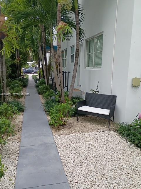 755 83rd Street, Unit 3 Miami Beach, FL 33141 - Photo 9 of 24 a white bench sitting in front of a house