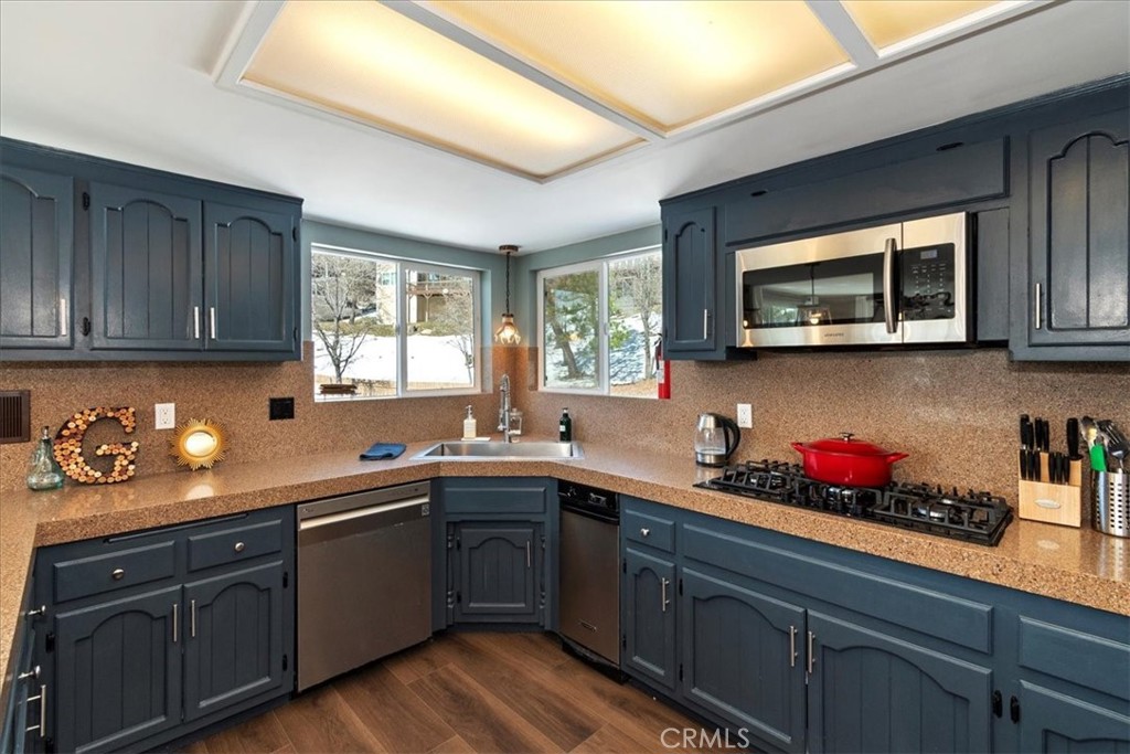 27814 North Bay Road Lake Arrowhead, CA 92352 - Photo 16 of 68 a kitchen with stainless steel appliances granite countertop wooden cabinets sink and a granite counter top