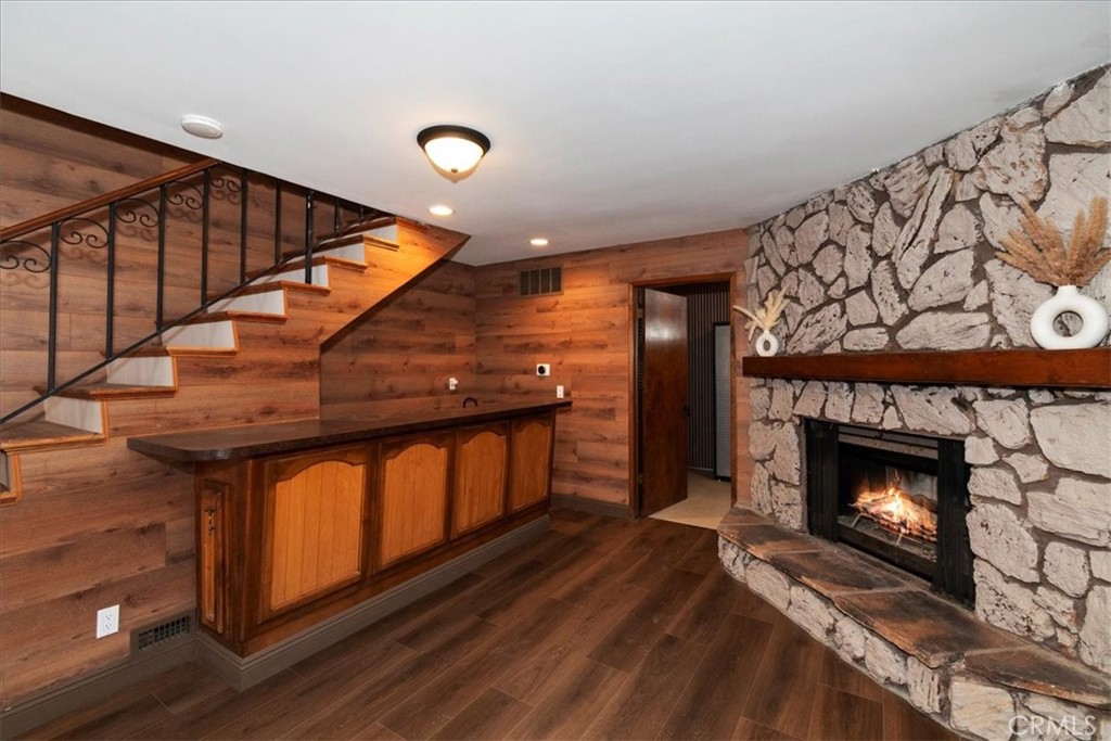27814 North Bay Road Lake Arrowhead, CA 92352 - Photo 25 of 68 a view of an empty room with wooden floor fireplace and a window