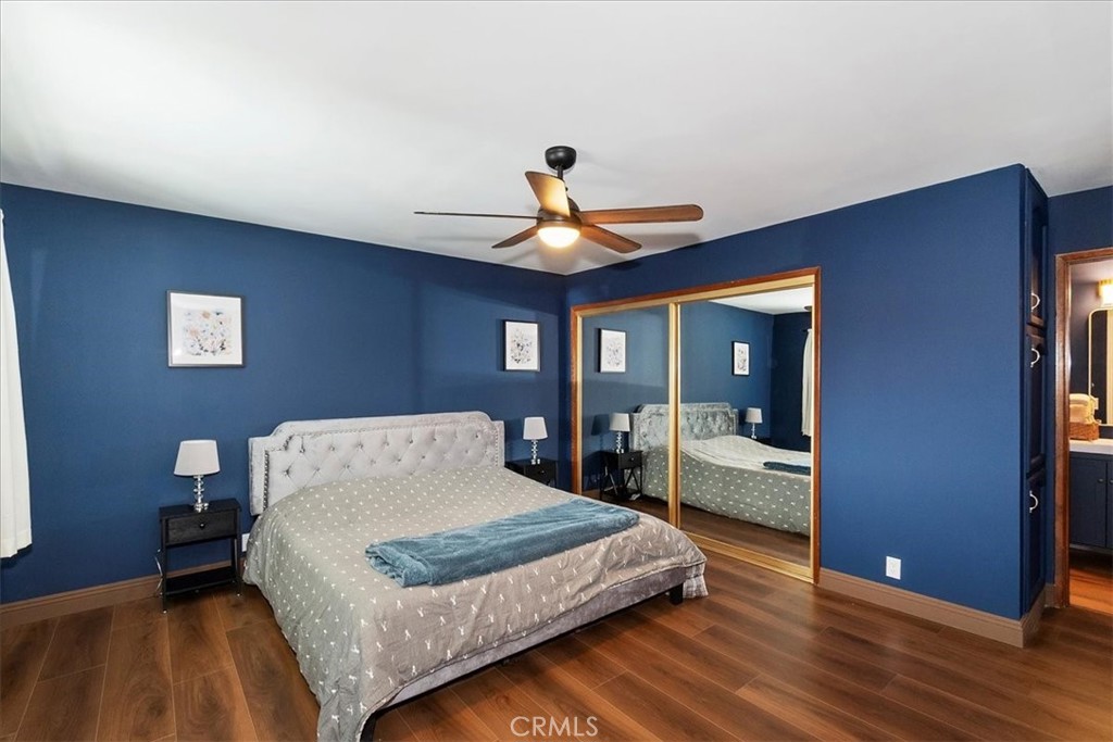 27814 North Bay Road Lake Arrowhead, CA 92352 - Photo 40 of 68 a bedroom with a large bed and a chandelier