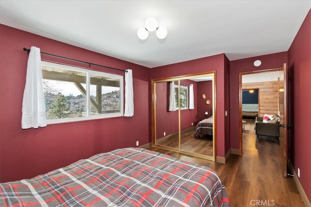 27814 North Bay Road Lake Arrowhead, CA 92352 - Photo 49 of 68 a bedroom with a bed and a chandelier