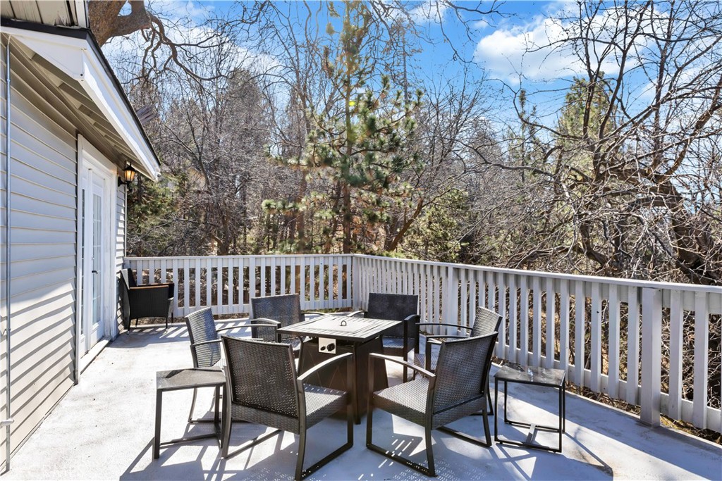 27814 North Bay Road Lake Arrowhead, CA 92352 - Photo 5 of 68 a view of a chair and table on the deck