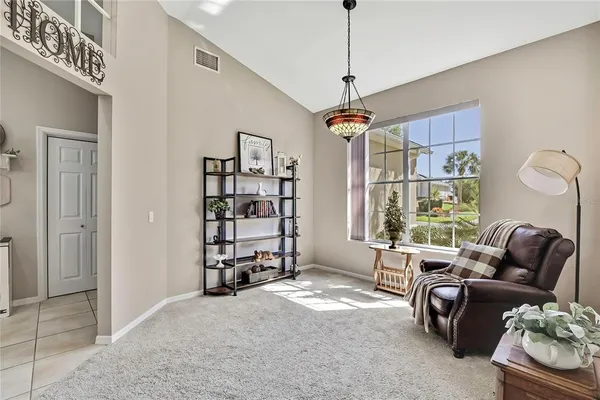 a living room with furniture windows and a chandelier