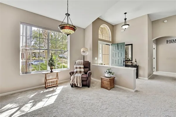 a living room with furniture and a chandelier