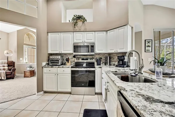 a kitchen with a sink cabinets and stainless steel appliances