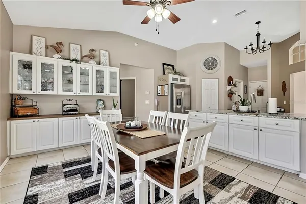 a kitchen with a refrigerator wooden cabinets and stove top oven