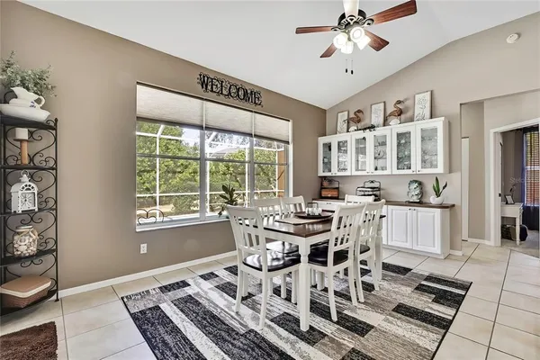 a spacious bedroom with a bed and a chandelier