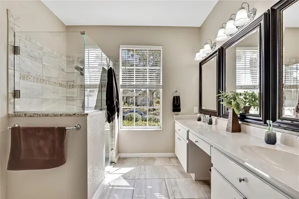 a bathroom with a granite countertop sink a toilet and shower