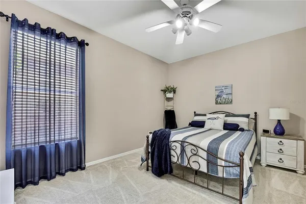 a view of a backyard with swimming pool and sitting area