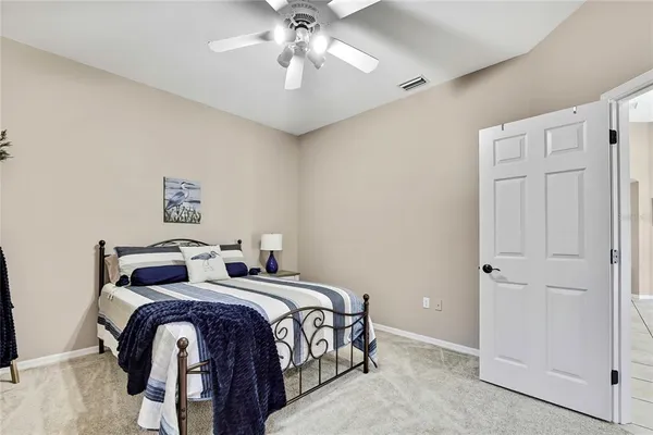 a view of a swimming pool with a patio and a yard