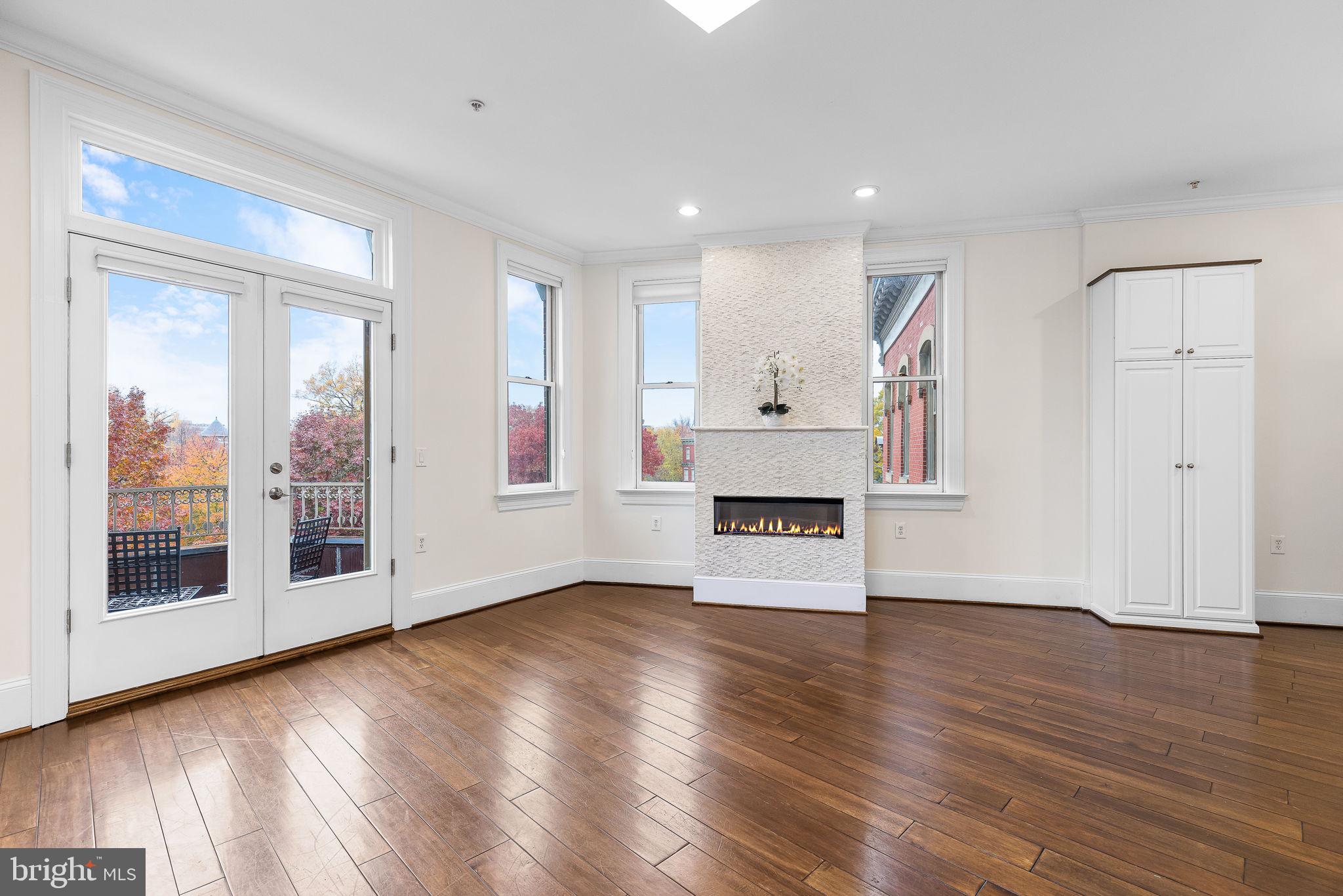 20 Logan Circle Northwest, Unit 33 Washington, DC 20005 - Photo 11 of 32 a view of empty room with wooden floor and fireplace