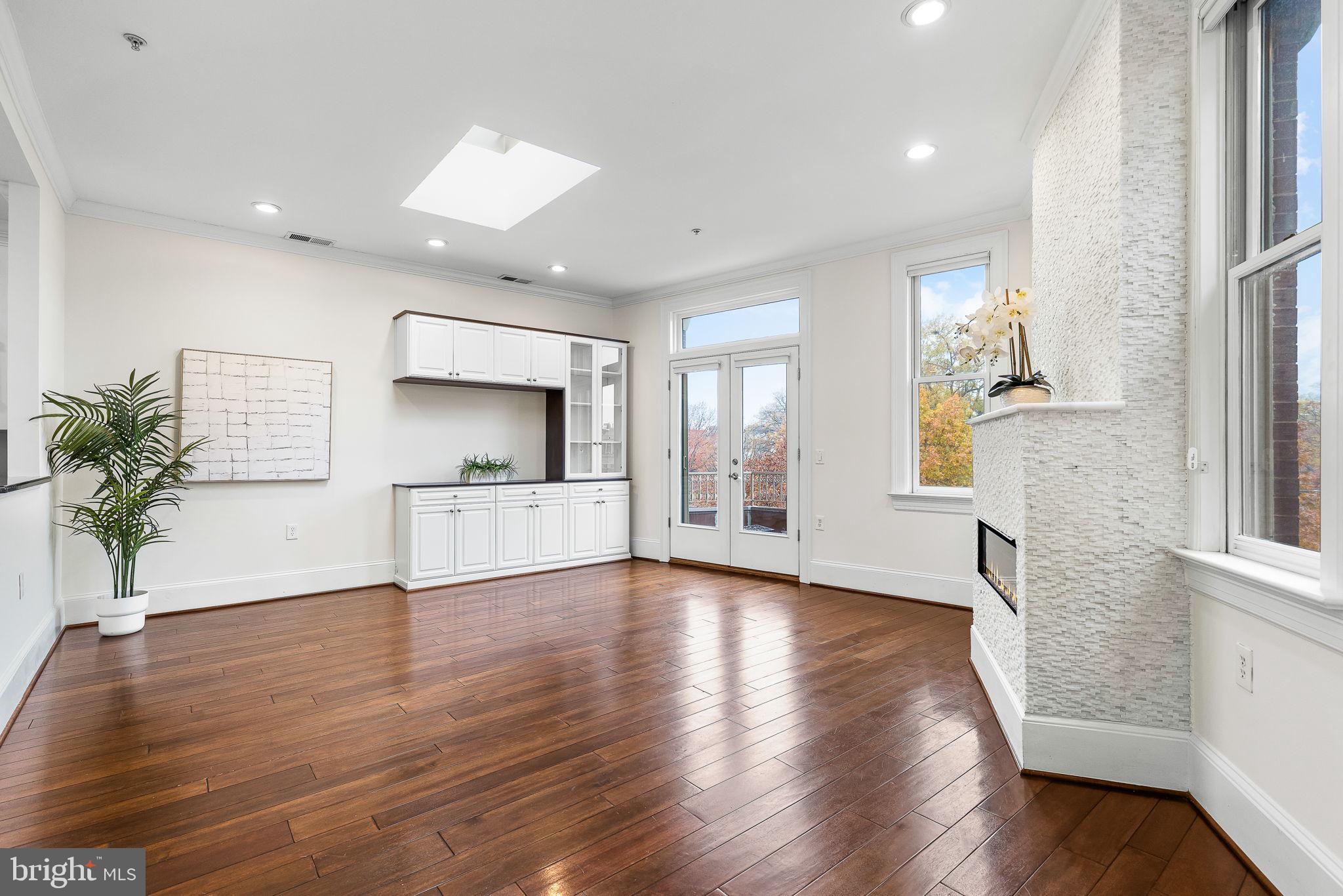 20 Logan Circle Northwest, Unit 33 Washington, DC 20005 - Photo 32 of 32 a view of empty room with wooden floor and fireplace