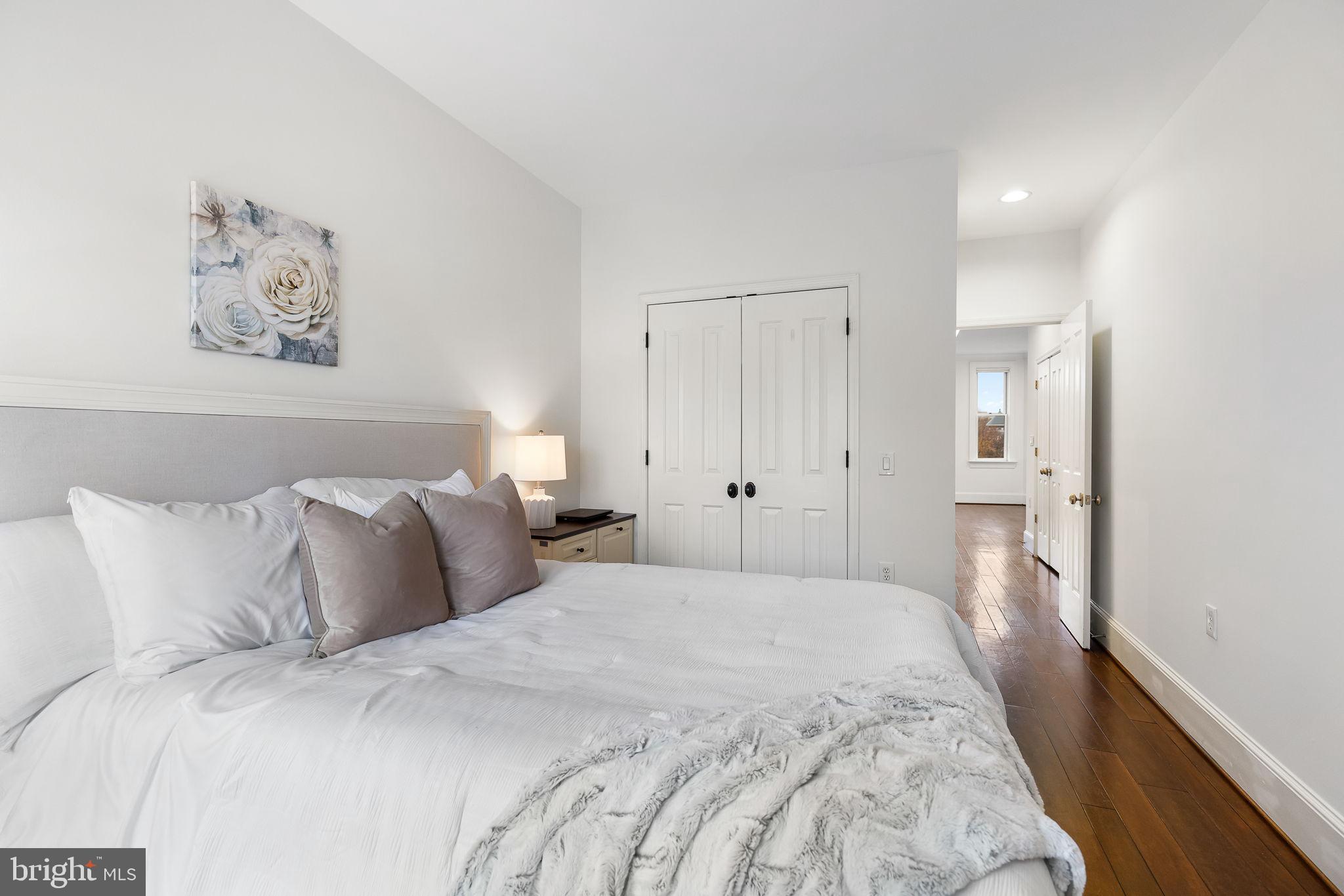 20 Logan Circle Northwest, Unit 33 Washington, DC 20005 - Photo 21 of 32 a bedroom with a bed and painting on the wall
