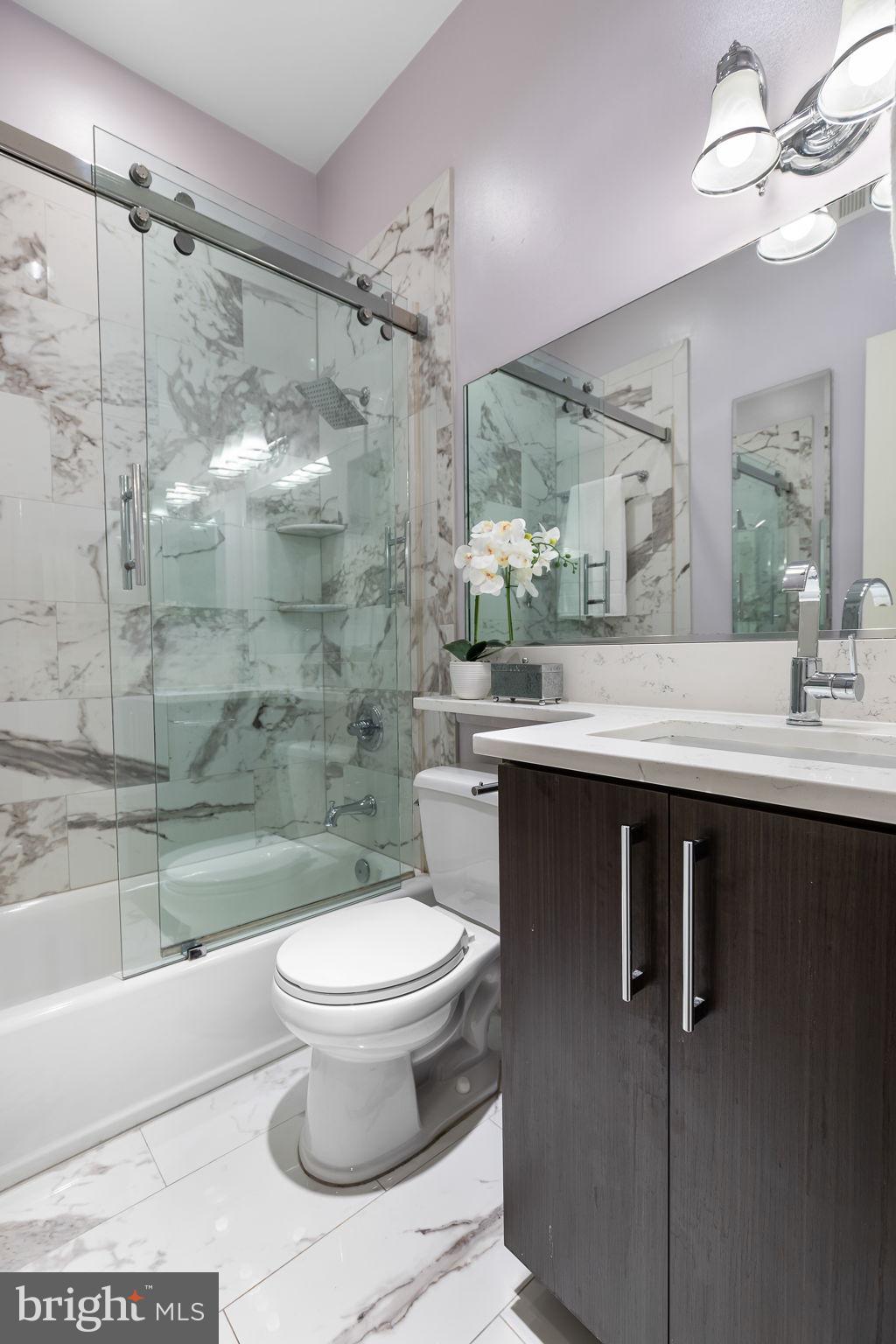 20 Logan Circle Northwest, Unit 33 Washington, DC 20005 - Photo 23 of 32 a bathroom with a sink toilet and shower