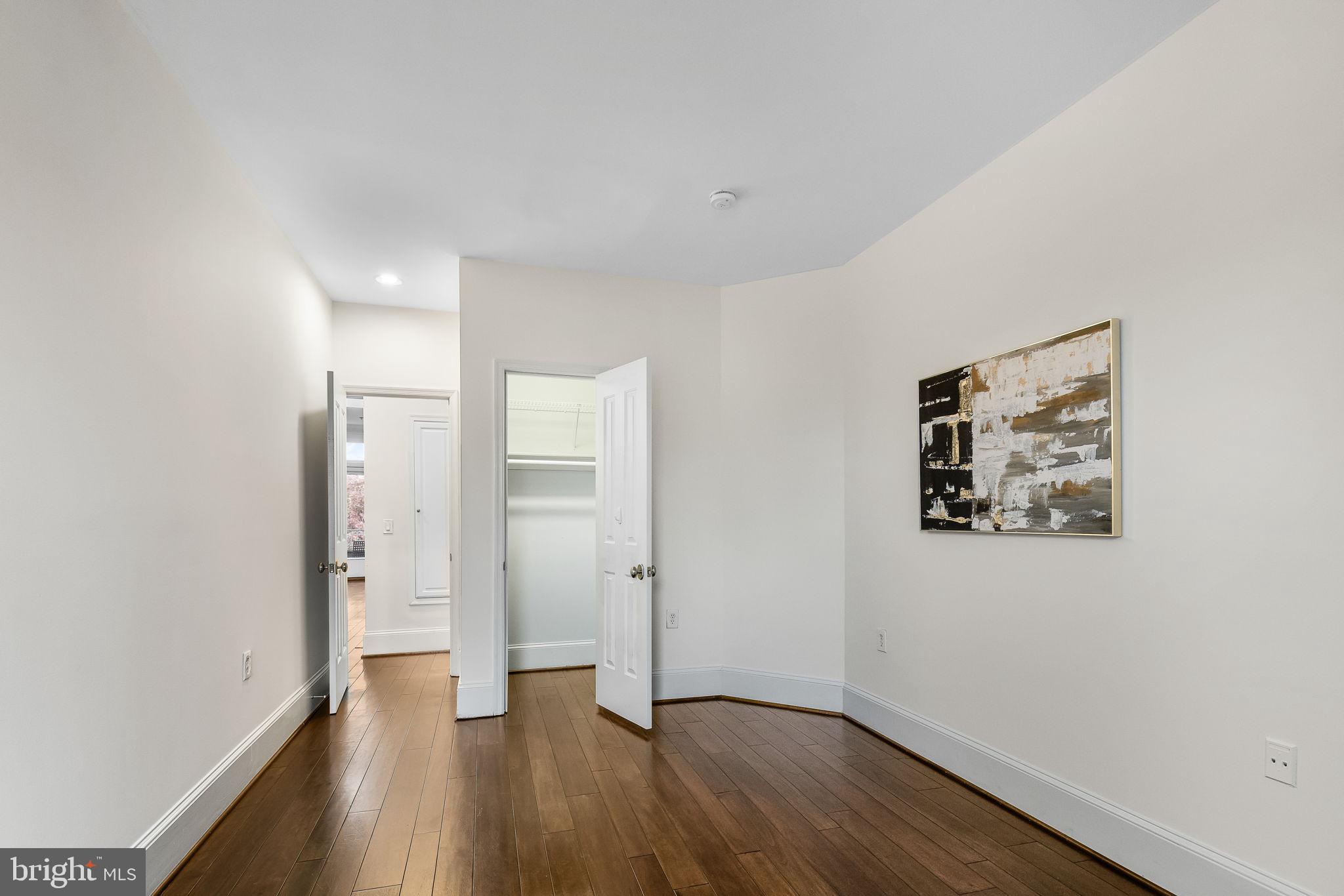 20 Logan Circle Northwest, Unit 33 Washington, DC 20005 - Photo 25 of 32 an empty room with wooden floor and windows