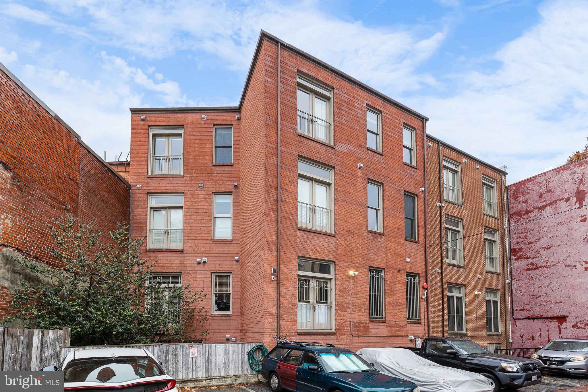 20 Logan Circle Northwest, Unit 33 Washington, DC 20005 - Photo 28 of 32 a front view of a building with lot of cars and trees