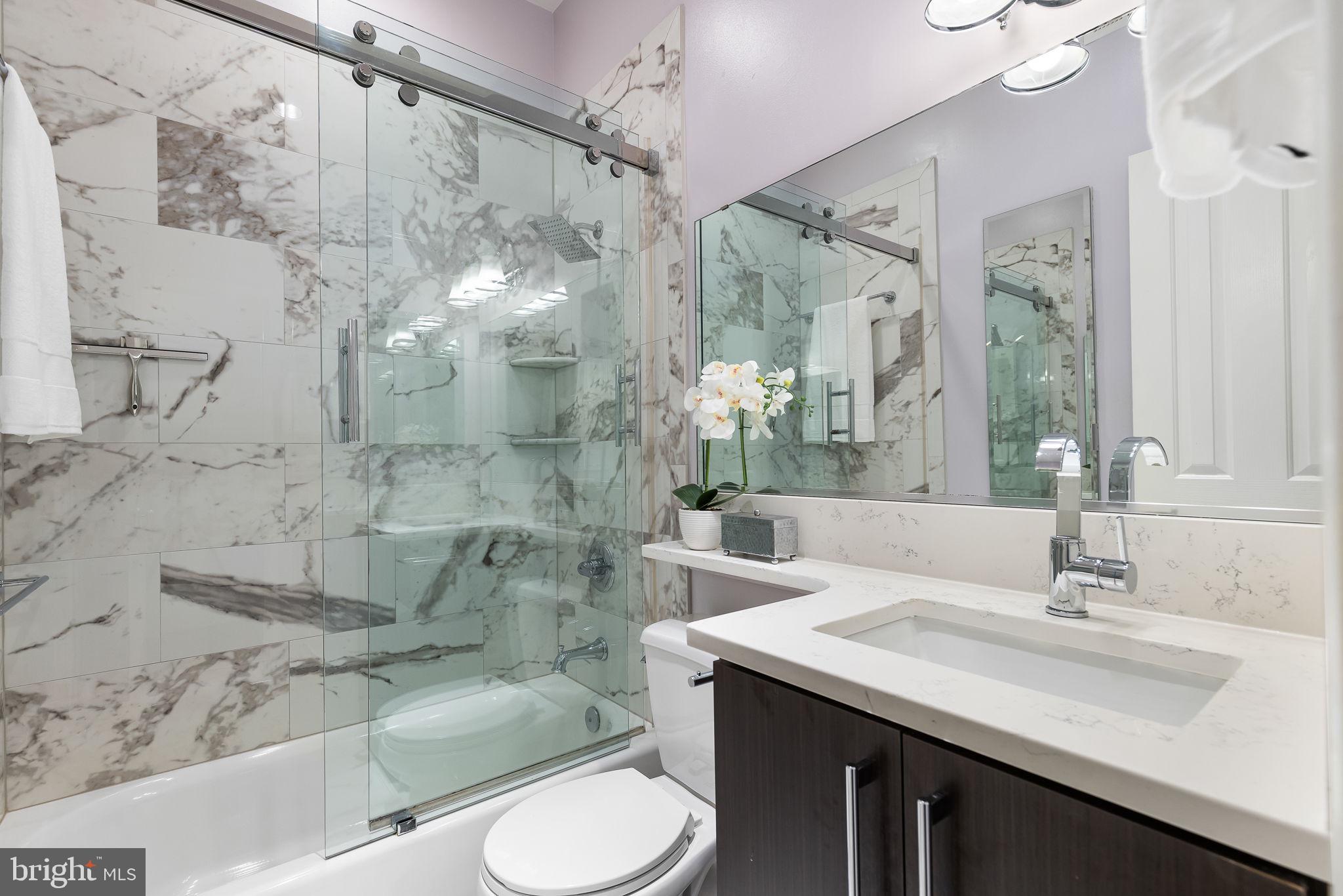 20 Logan Circle Northwest, Unit 33 Washington, DC 20005 - Photo 6 of 32 a bathroom with a sink vanity granite toilet and shower
