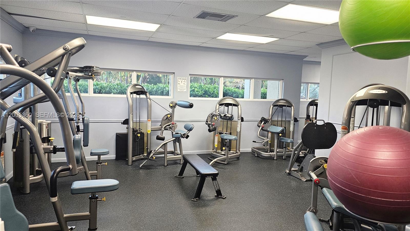 4001 North Ocean Boulevard, Unit 702 Boca Raton, FL 33431 - Photo 39 of 56 a room with gym equipment and a large window