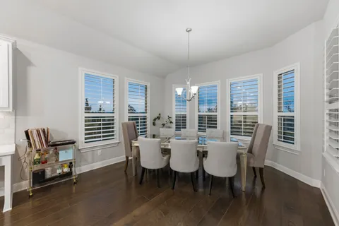 a view of a dining room with furniture and window