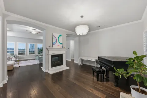 a living room with furniture and a piano