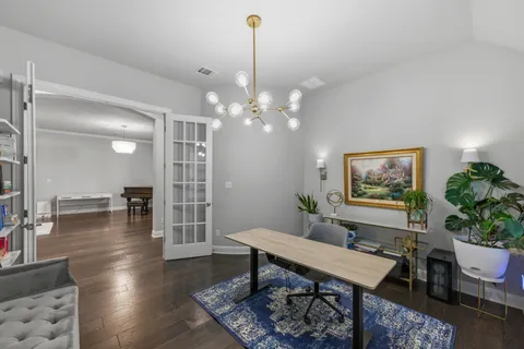 a living room with furniture a window and a chandelier