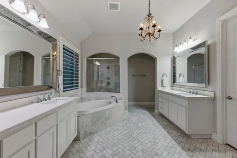 a spacious bedroom with a bed and a flat screen tv