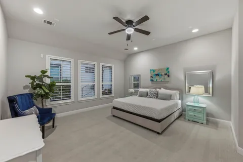 a spacious bathroom with a granite countertop sink a mirror and a bathtub