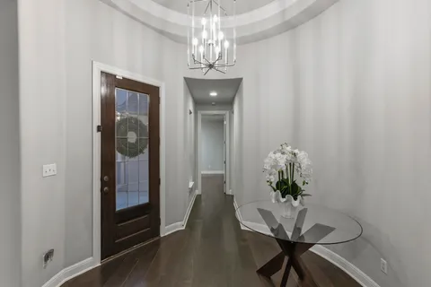 a dining room with furniture and chandelier
